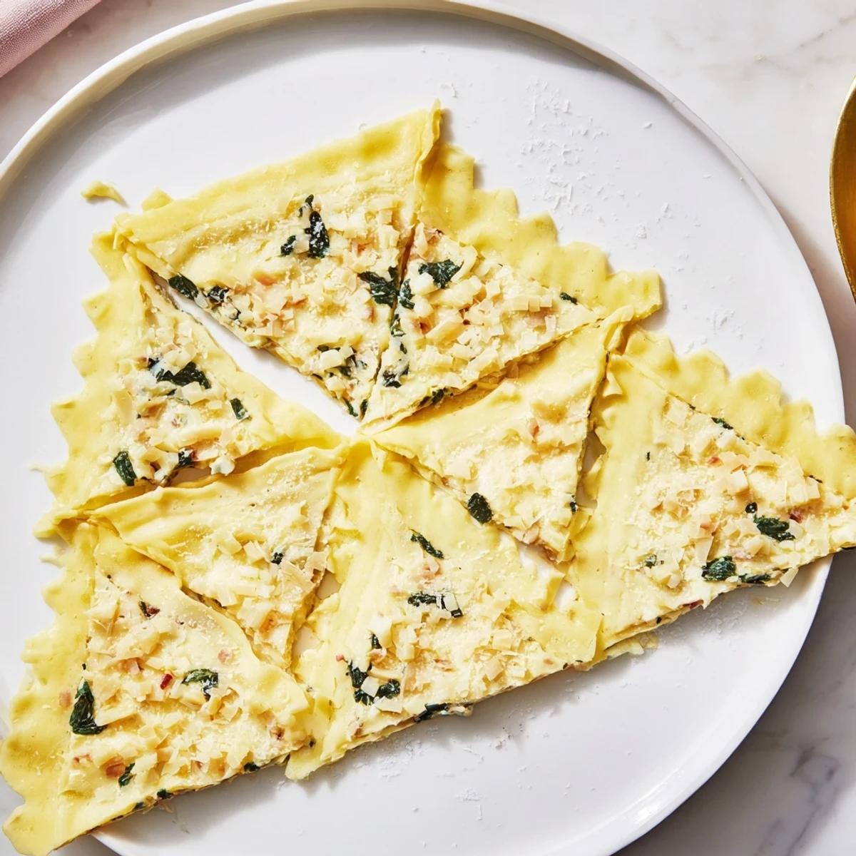 Flaky, golden baked savory spinach and ricotta puff pastry triangles, perfect for a vegetarian meal.