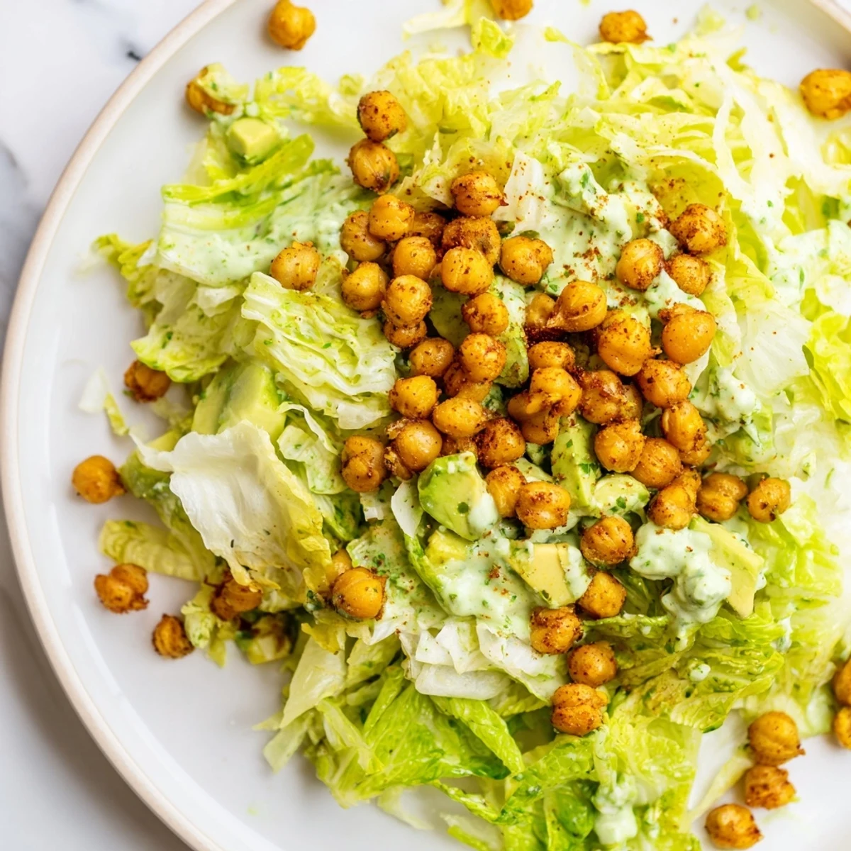 A bright bowl of Green Goddess Salad, boasting crispy chickpeas atop a creamy, herb-packed dressing.