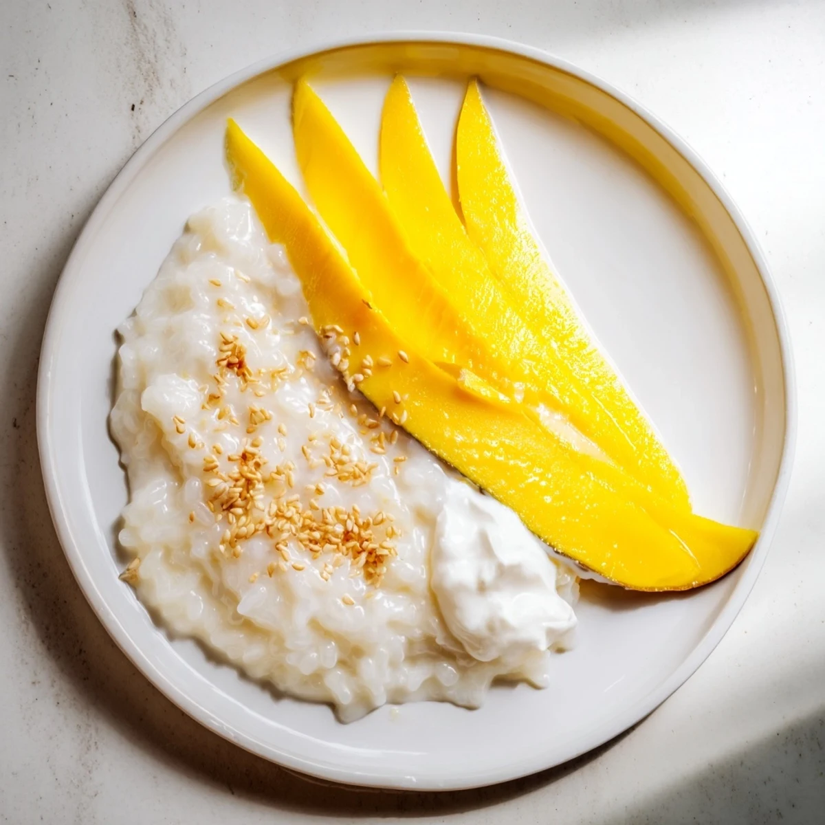 Delectable Thai Mango Sticky Rice served with fresh, vibrant mango for a sweet, tropical treat.