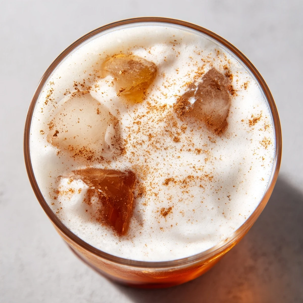 Homemade iced chai tea with aromatic spices and a rich cold foam, creating a refreshing afternoon beverage.
