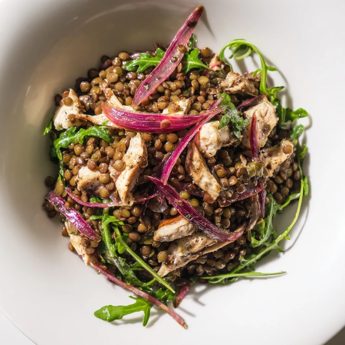 Freshly cooked lentils and juicy roasted chicken mingle with crisp arugula and tangy pickled onions in this vibrant Lentil & Chicken Spring Salad, tossed in a zesty mustard dressing.  