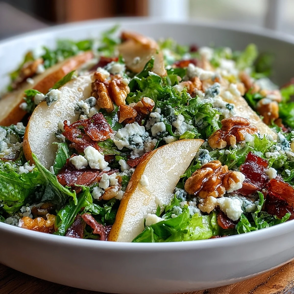 A fresh serving of Frisée Pear Blue Cheese Bowl, mixing crisp frisée greens, ripe sliced pears, and creamy crumbled cheese.