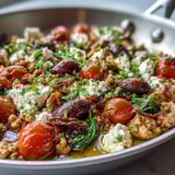 Colorful bowl of Mediterranean Keto Ground Chicken Skillet, featuring ground chicken, cherry tomatoes, Kalamata olives, and creamy feta.