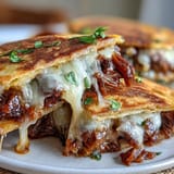 Cheesy, shredded beef Birria Quesadillas ready for a flavorful consommé dip.