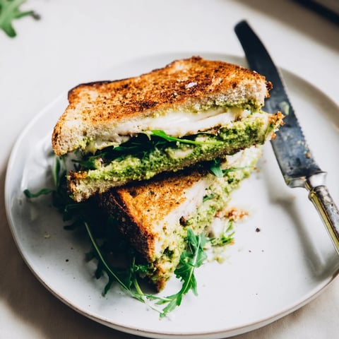 Spring Pea Pesto Grilled Cheese on golden, crispy sourdough, layered with melty mozzarella and vibrant green pea pesto.