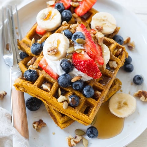 Golden, fluffy Anti-Inflammatory Adaptogenic Turmeric Waffles fresh from the waffle iron, ready for toppings.