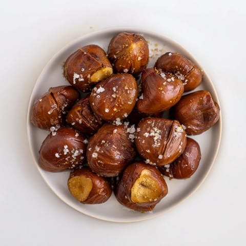 Close-up of freshly baked sweet and salty honey toasted cashews, glistening with a sea salt finish.