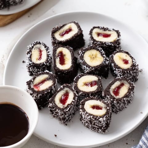 Sweet Oreo Cookie Sushi Rolls with banana filling, ready to serve with chocolate sauce.