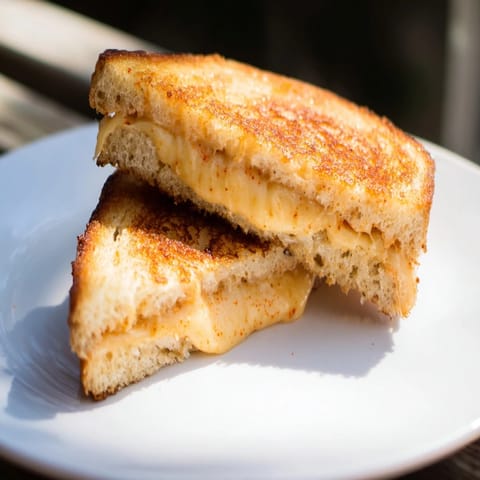 Crispy sourdough and spicy-sweet honey butter on this Honey Chipotle Butter Grilled Cheese sandwich.