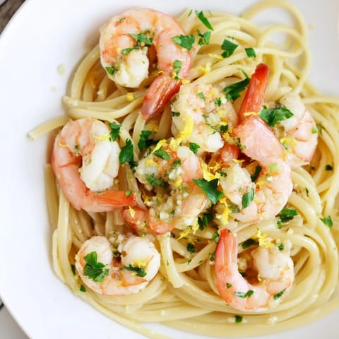 Freshly cooked Lemon Garlic Shrimp Pasta showcases plump pink shrimp and glossy strands of spaghetti in a zesty, garlicky lemon butter sauce.  