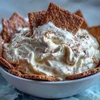 Creamy, dreamy cheesecake dip with graham crackers, perfect for dipping and sharing at any party or gathering.