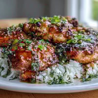 Honey Garlic Chicken with Rice in a slow cooker, tender chicken thighs simmered in sweet and savory sauce over fluffy jasmine rice.